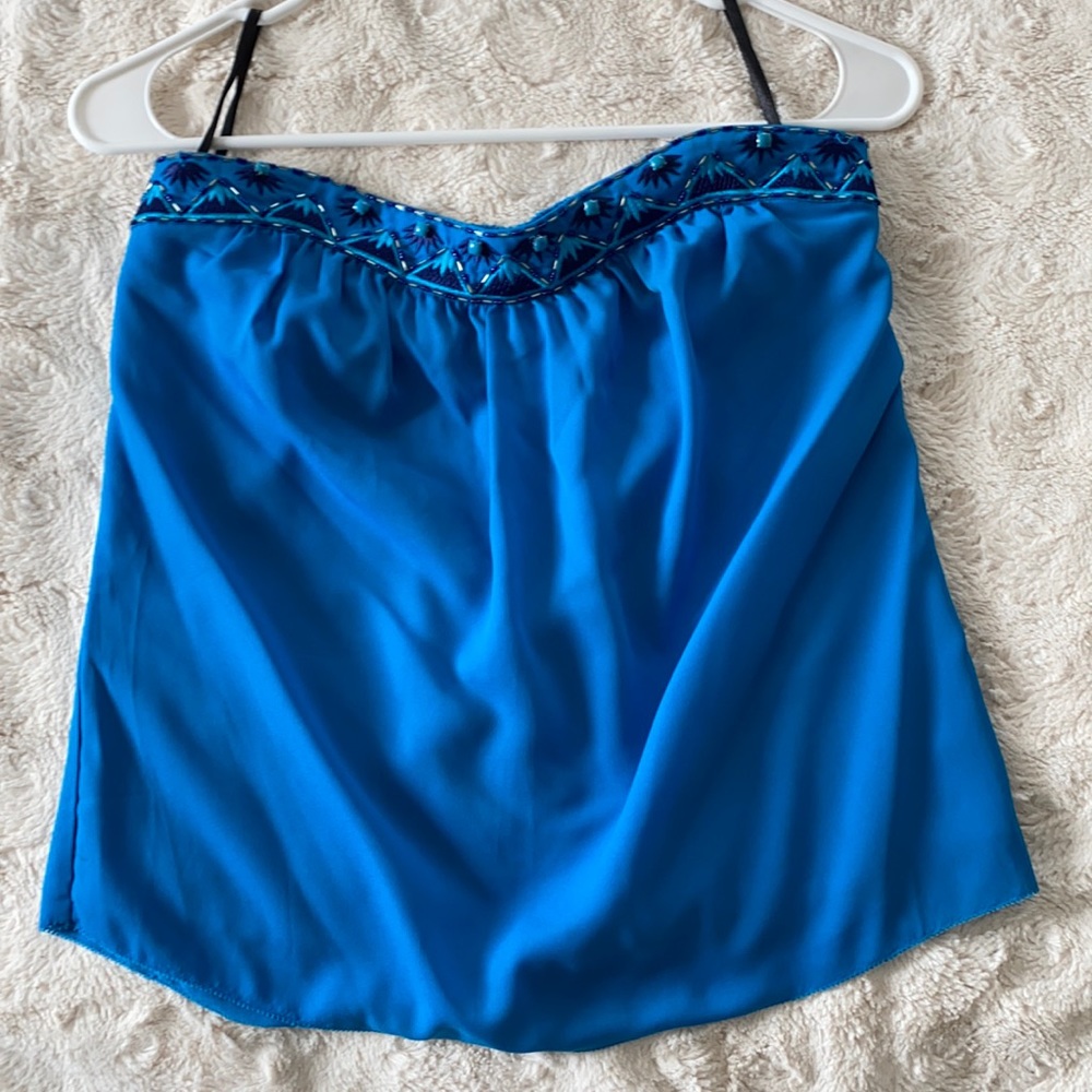 Strapless top with beaded trim.